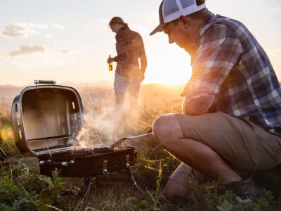 People cooking on a portable barbecue. Photo: Unsplash