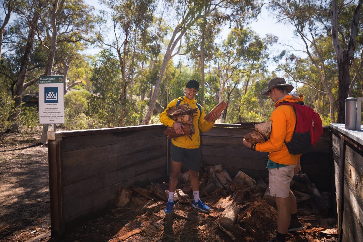 Two people collecting firewood at Ganguddy-Dunns Swamp campground in Wollemi National Park. Photo: Daniel Tran/DPIE