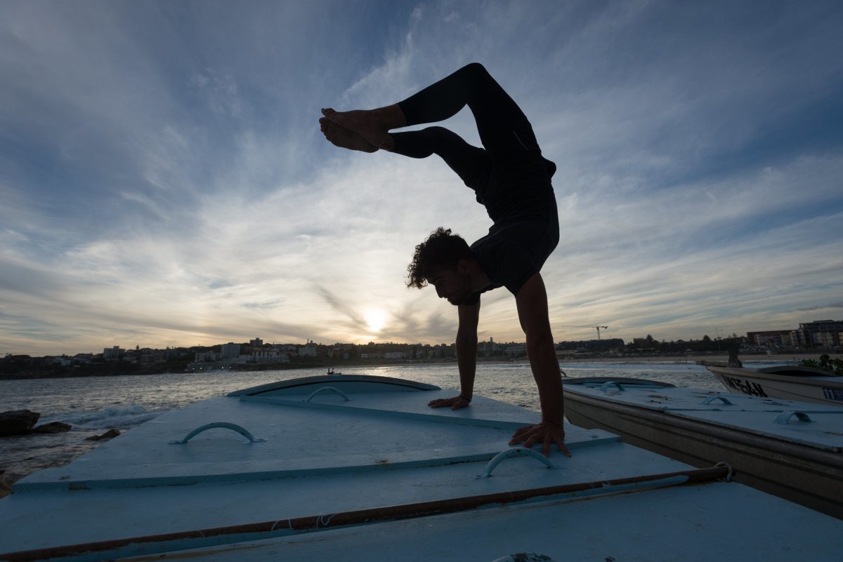 Person doing a handstand on a boat. Photo: Seb Ruiz