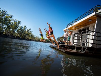 Children jump off a boat into the Murray River. Photo: Destination NSW