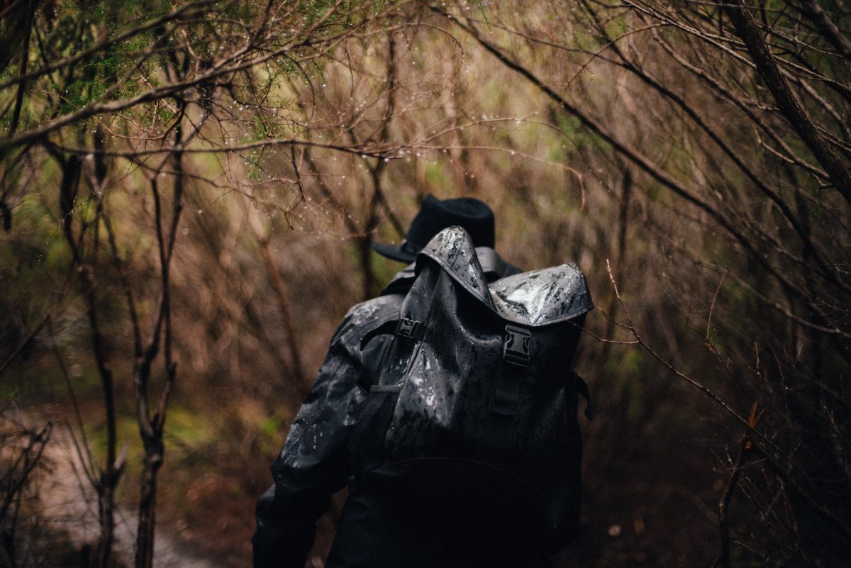 Man with backpack hiking through Blue Mountains National Park. Photo: Adrian Mascenon