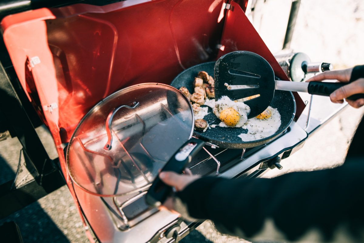 Fried eggs on portable camping stove. Photo: Stocksy