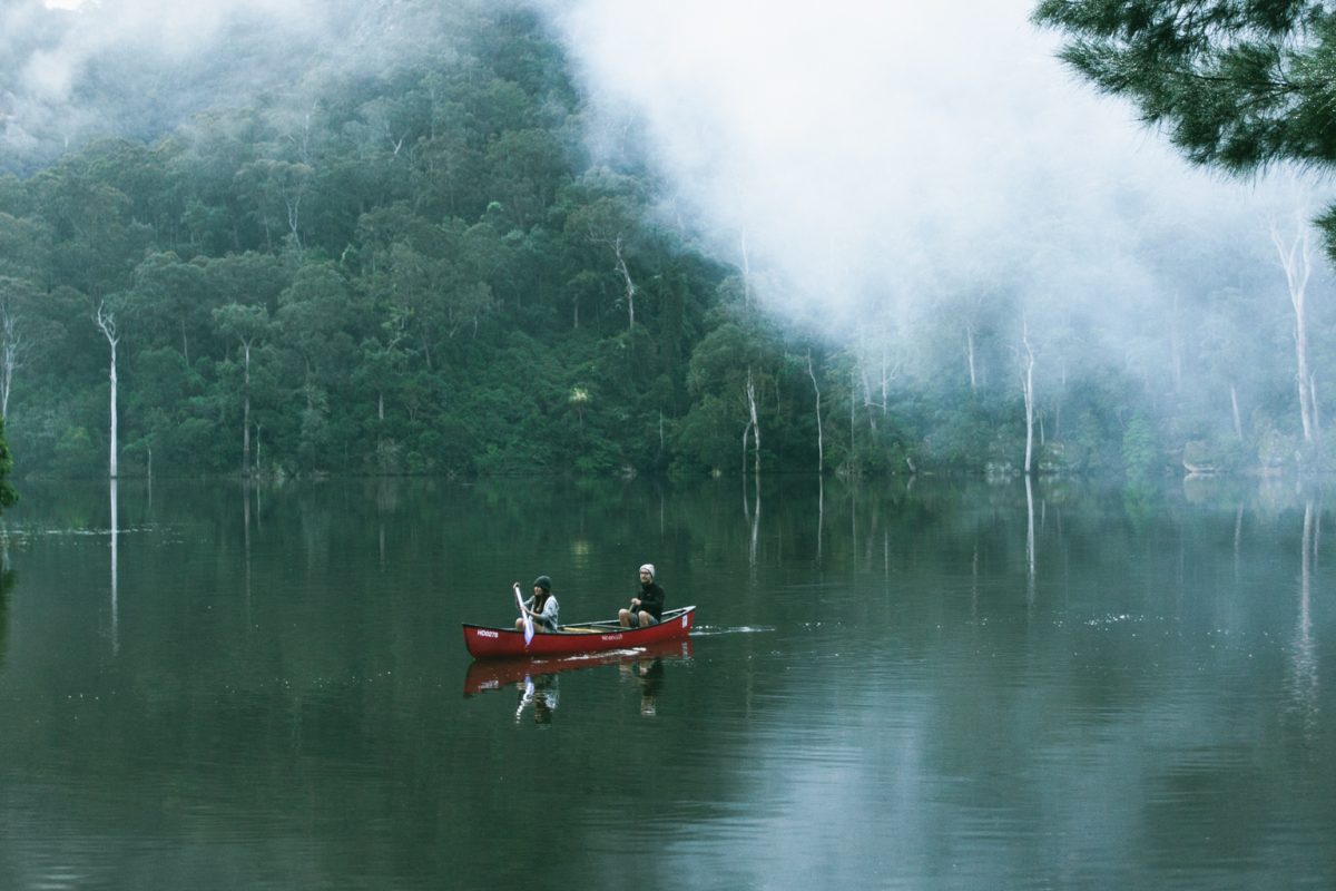 People canoeing and surrounded by fog, Morton National Park. Photo: Tim Clark