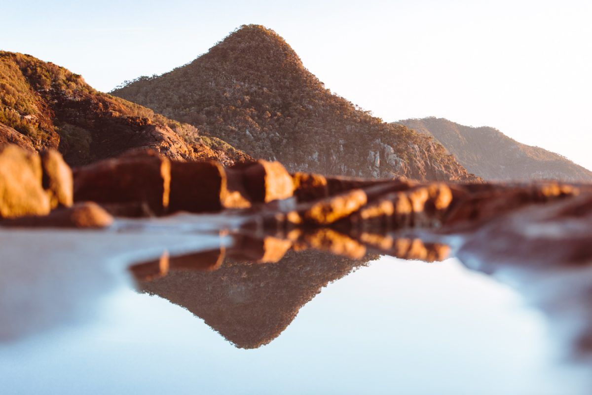 Reflections of a mountain in a rockpool, Tomaree National Park. Photo: Tim Clark