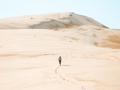 Person running up the Stockton sand dunes, Worimi National Park. Photo: Tim Clark
