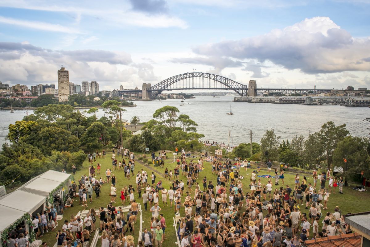 People relaxing before the Sydney Harbour New Year's Eve fireworks at Goat Island, Sydney Harbour National Park. Photo: John Spencer/DPIE