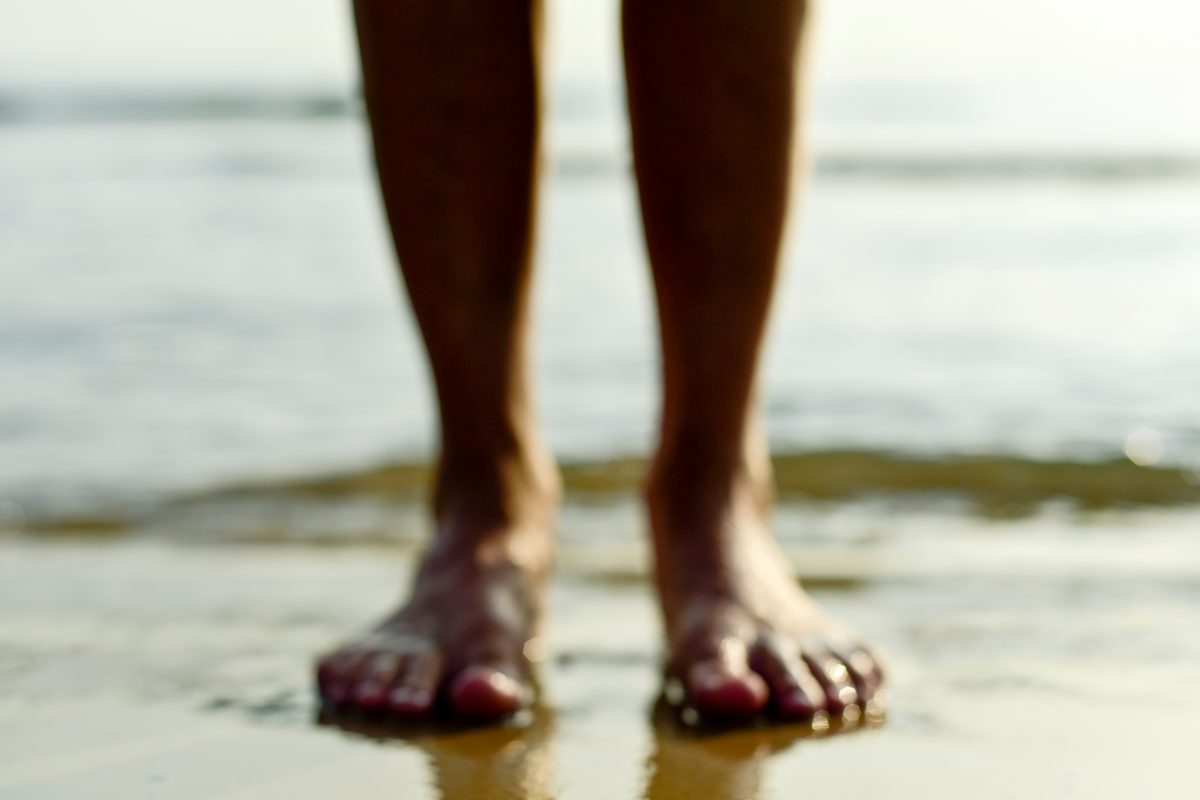 Generic image of feet in the sand