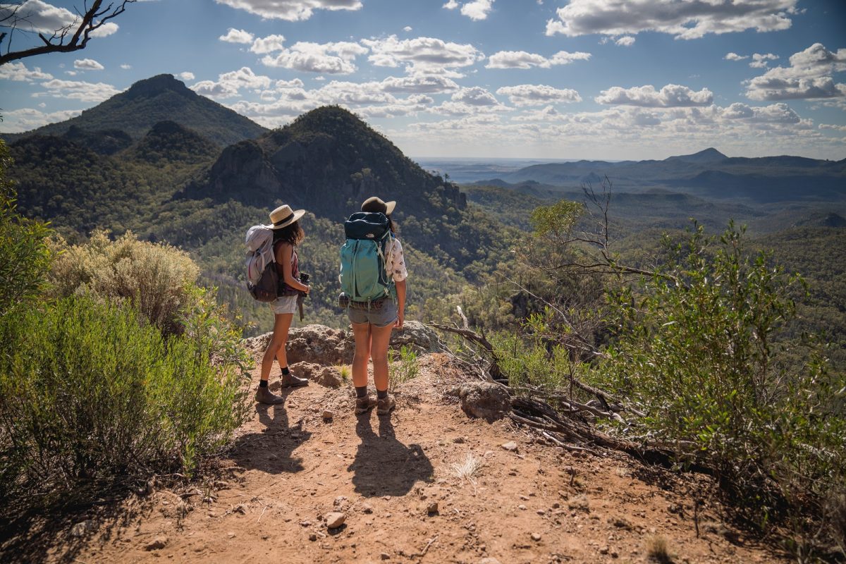 Two hikers on Breadknife and Grand High Tops walk in Warrumbungle National Park. Photo: Rob Mulally/DPIE
