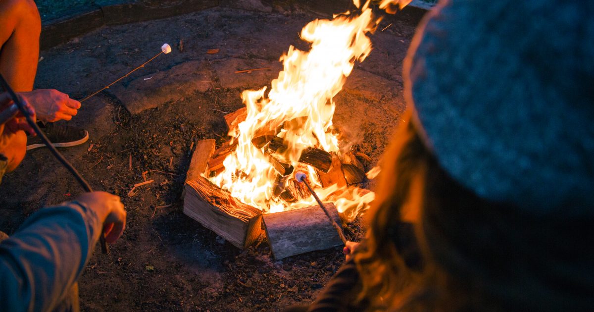 People toasting marshmallows around a fire at The Basin campground in Ku-ring-gai Chase National Park. Photo credit: Tim Clark / DPE