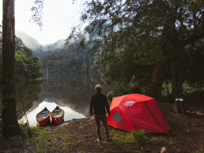 Person camping by the water, Morton National Park. Photo: Tim Clark