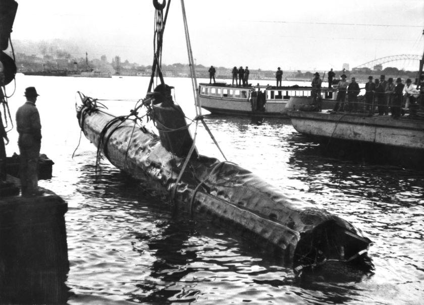 An historical image of a wrecked submarine being hauled out of Taylor’s Bay, 1943