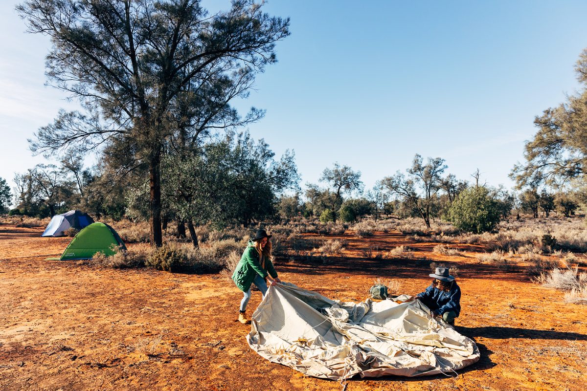 Two women setting up a tent at Main campground in Mungo National Park. Photo credit: Melissa Findley/DPIE