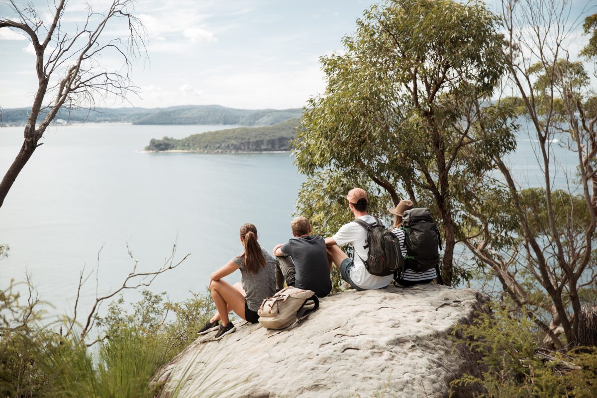 A group of people sitting on a rock, Ku-ring-gai Chase National Park. Photo: Tim Clark