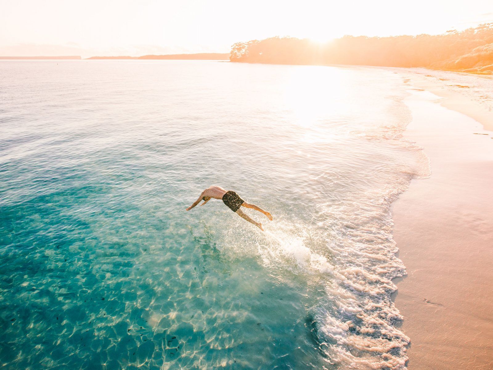 Person diving into the ocean near a NSW national park. Photo: DPIE
