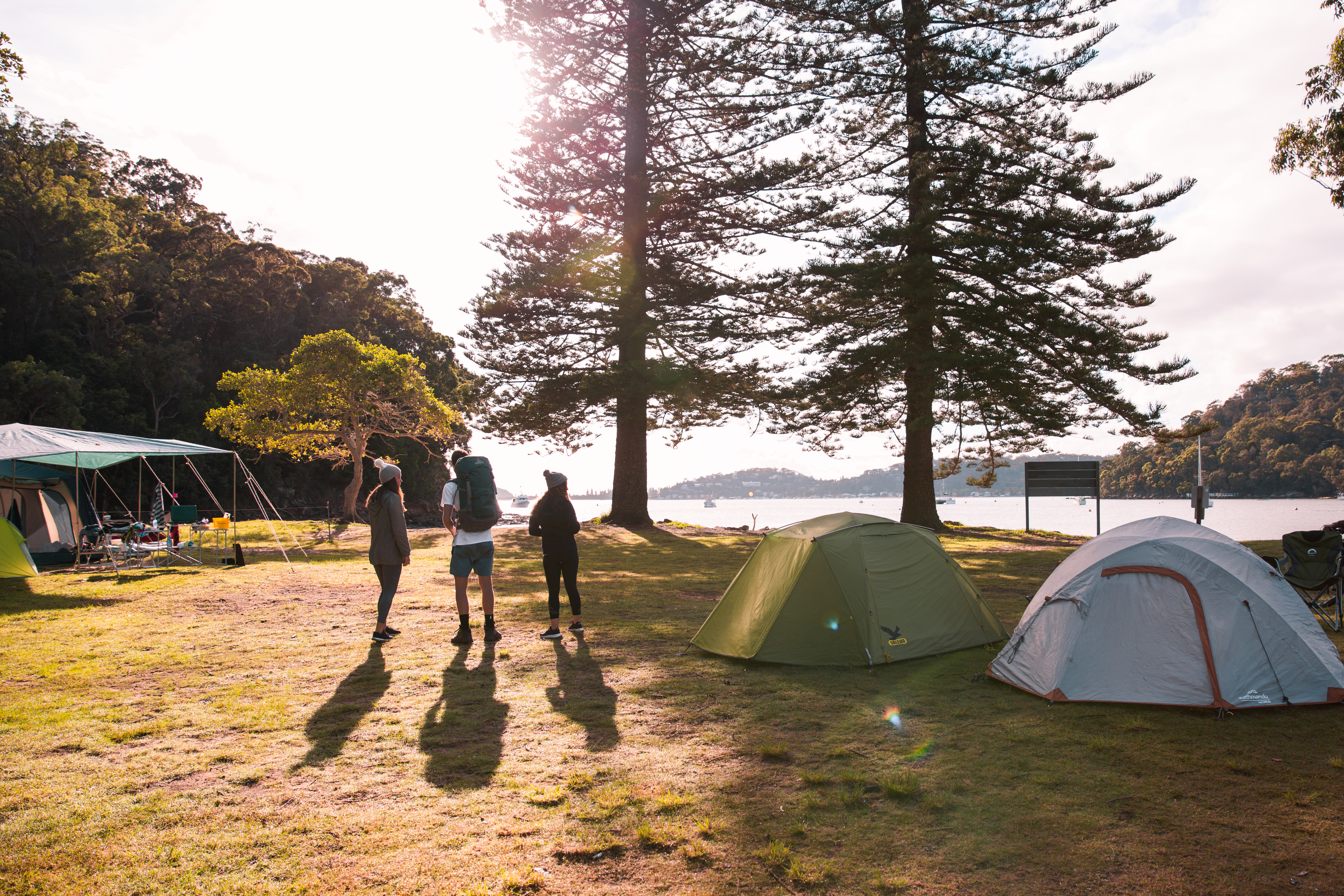 Group of people and tents at The Basin campground in Ku-ring-gai Chase National Park. Photo credit: Tim Clark / DPE