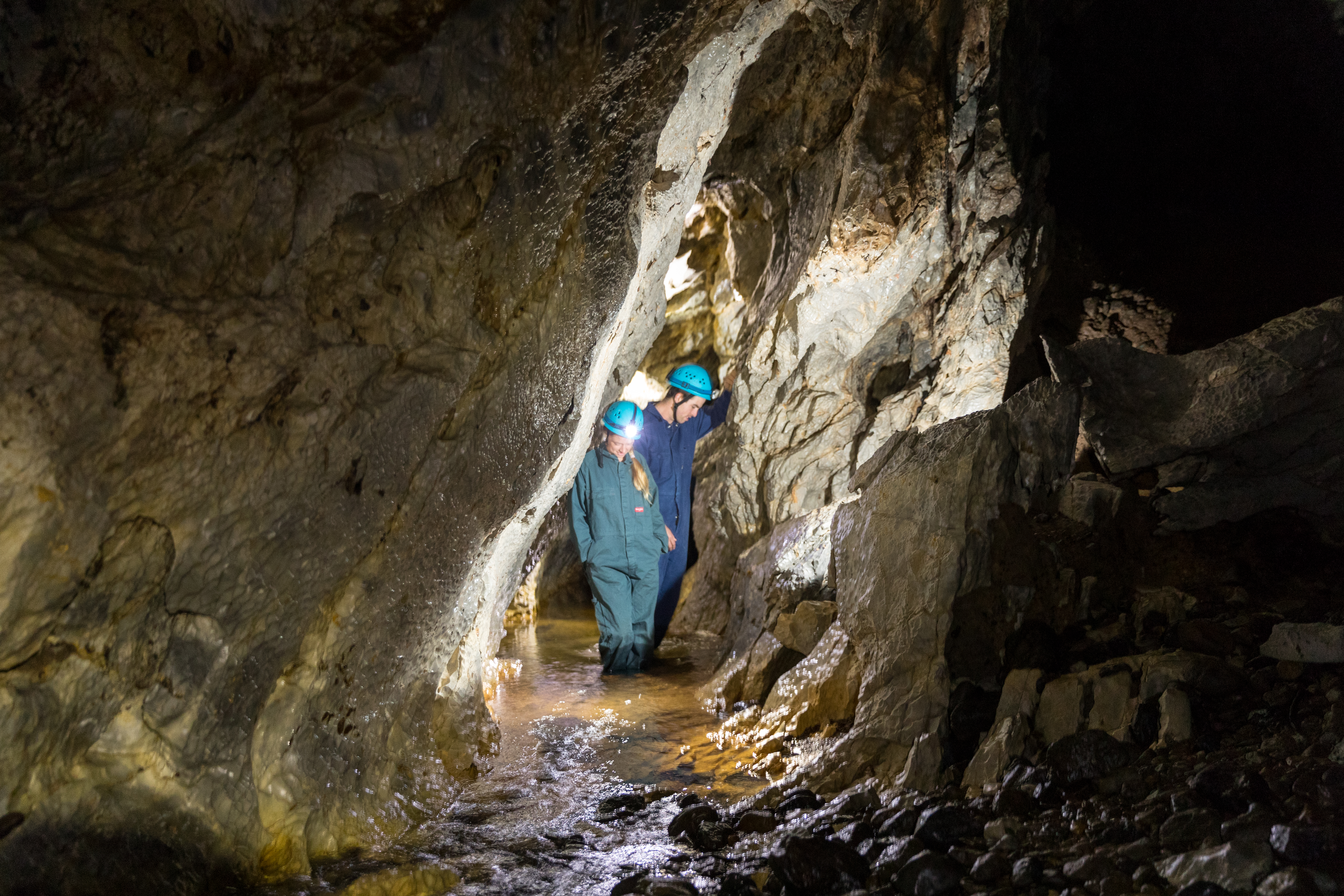 Two people walking through Yarrangobilly Caves in Kosciuszko National Park. Photo credit: Boen Ferguson/DPIE