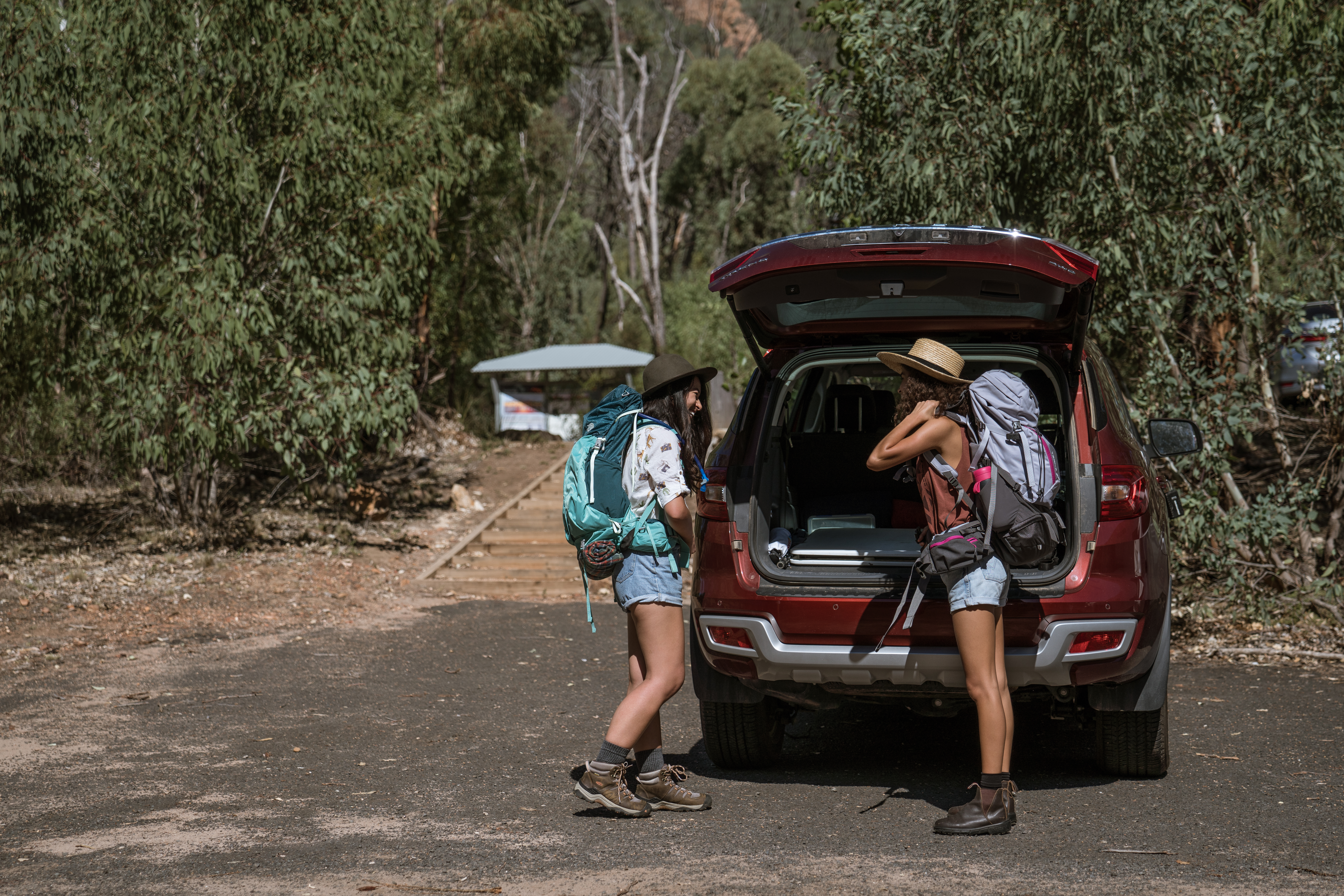 Two people preparing to go hiking in Warrumbungle National Park. Photo credit: Rob Mulally/DPIE
