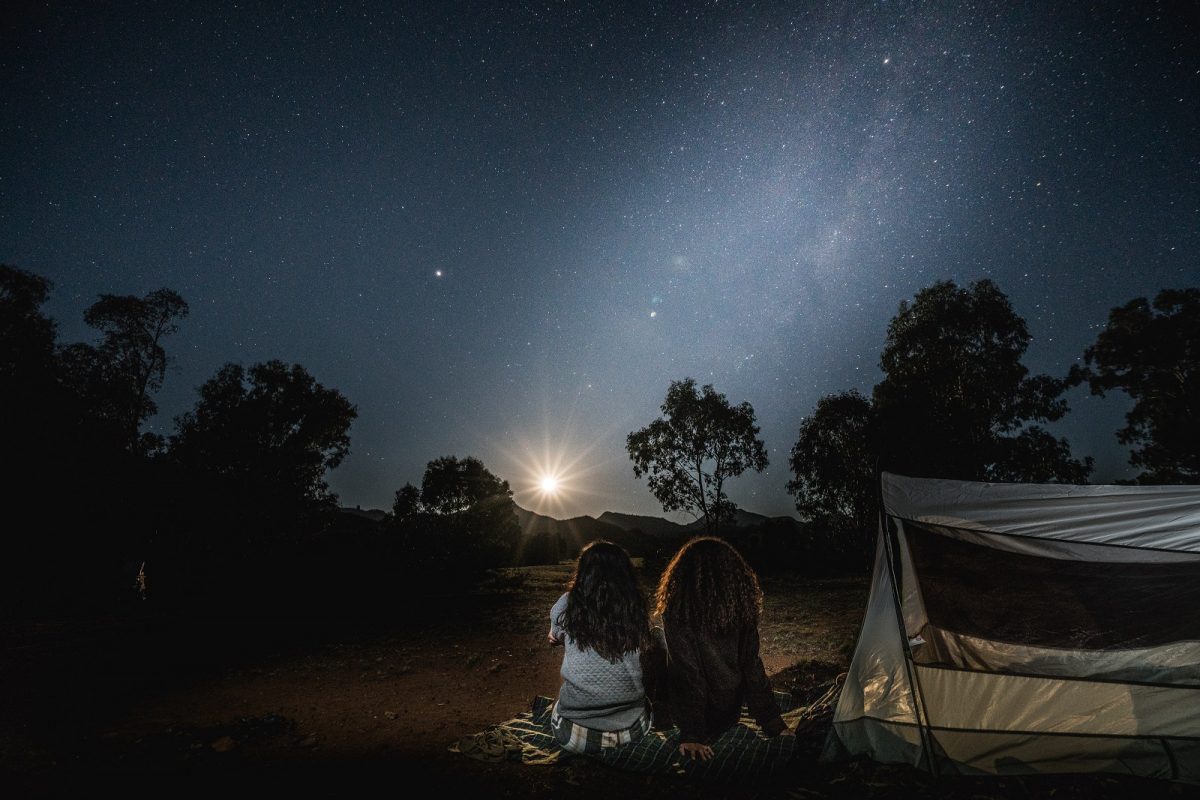 Two people camping under the stars at Warrumbungle National Park. Photo credit: Rob Mulally/DPIE