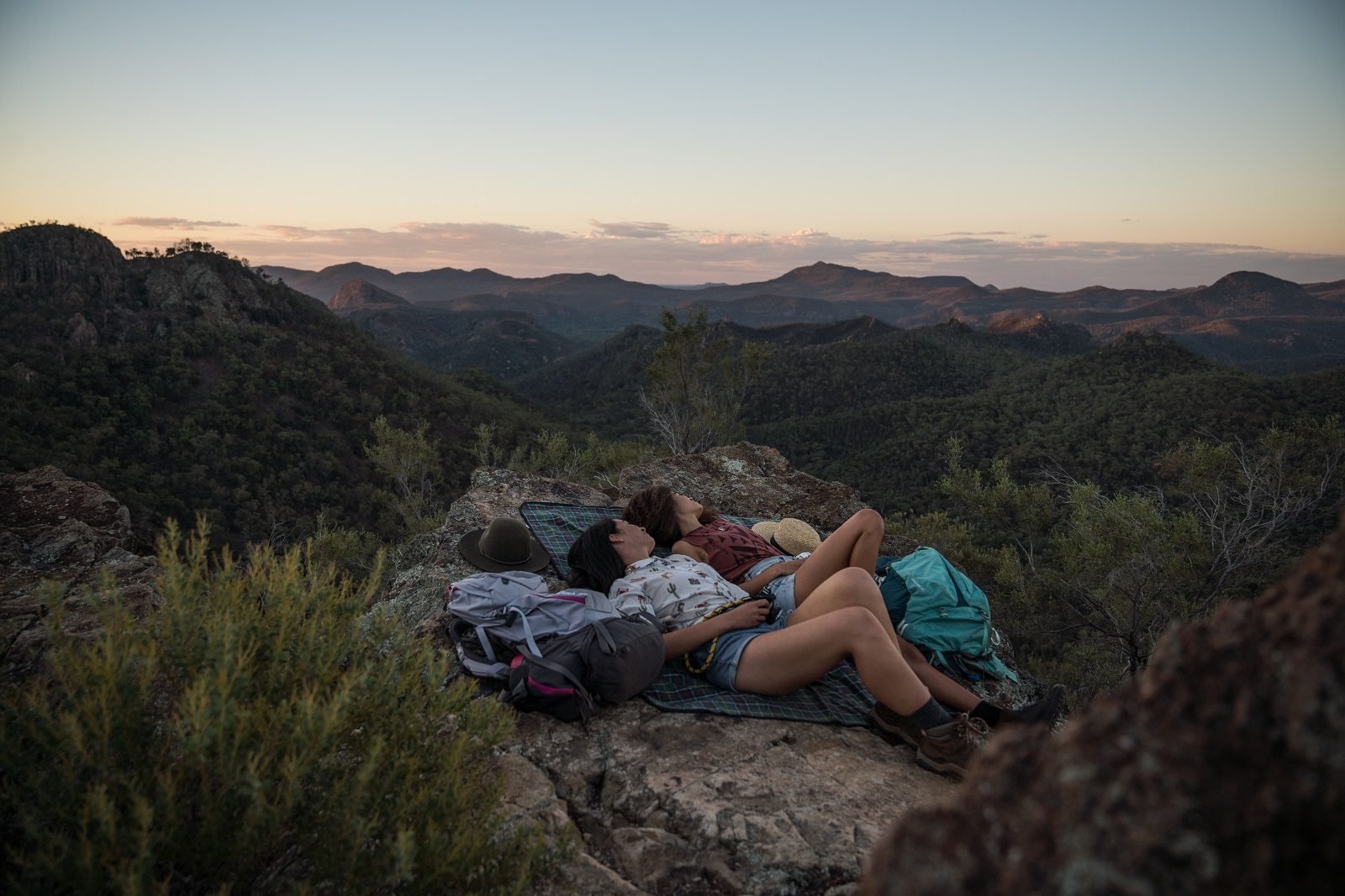 Couple relaxing at sunset in Warrumbungle National Park. Photo credit: Rob Mulally/DPIE