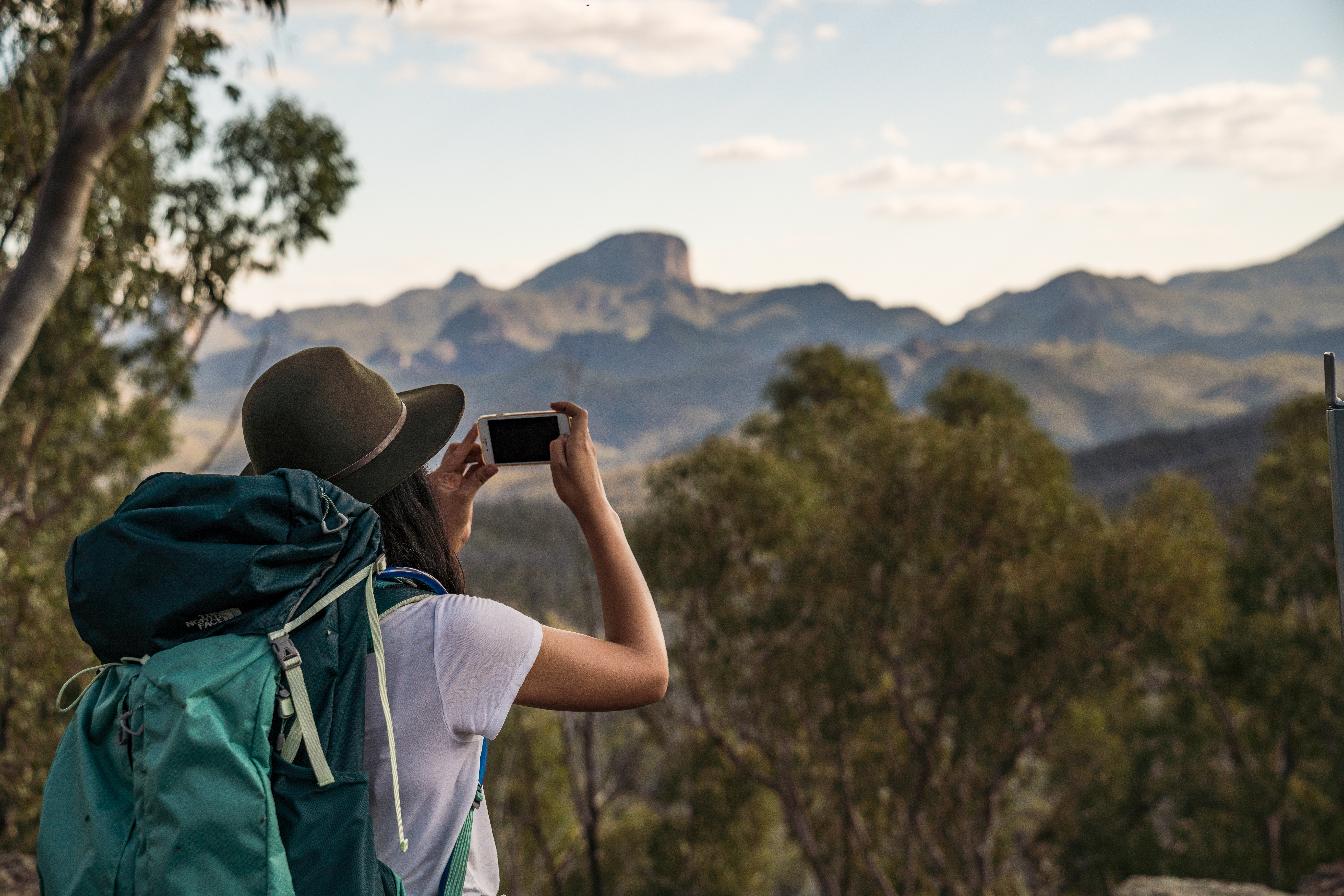 Hiker taking a photo in Warrumbungle National Park. Photo credit: Rob Mulally/DPIE