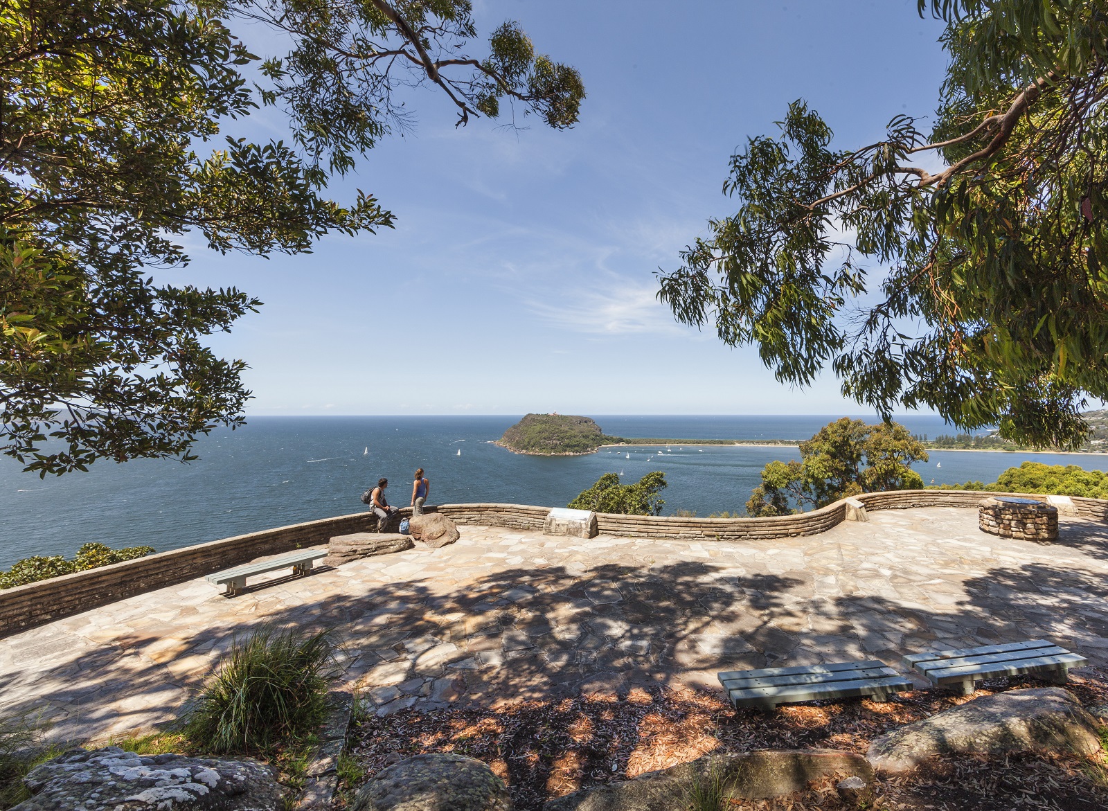Two people enjoying scenic views from West Head lookout in Ku-ring-gai Chase National Park. Photo credit: David Finnegan/DPIE