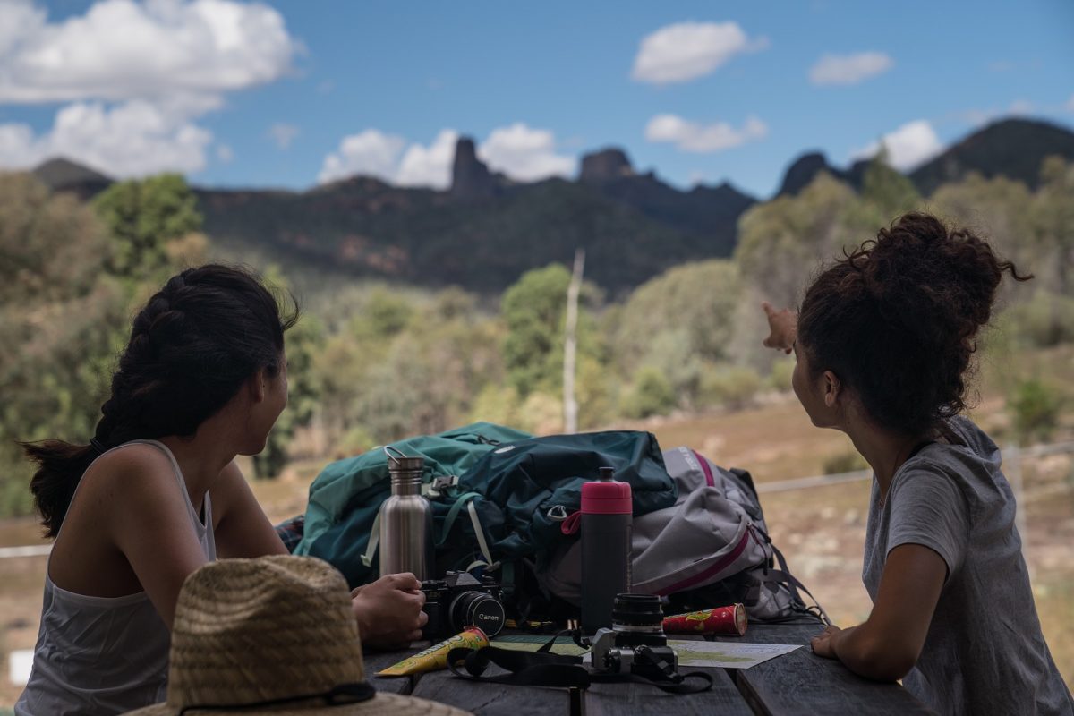 Two people resting on the Breadknife and Grand High Tops walk in Warrumbungle National Park. Photo: Rob Mulally/DPIE