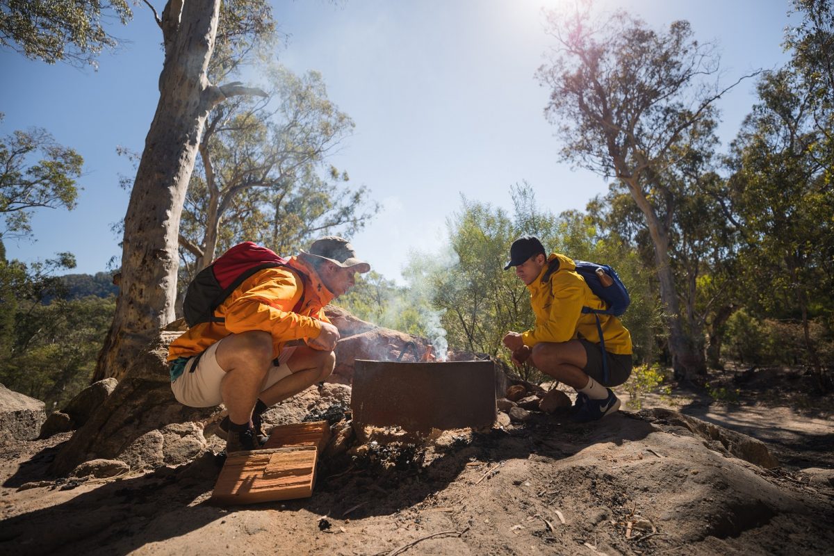 Two people around a campfire in Wollemi National Park. Photo credit: Daniel Tran/DPIE