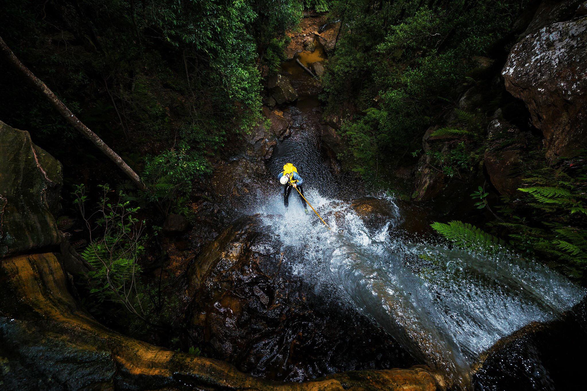 A person abseiling down Empress Canyon in Blue Mountains National Park. Photo: Jake Anderson