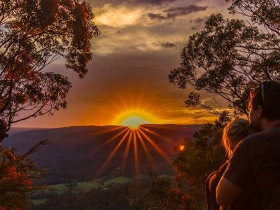 Two people sitting at Monkey Face lookout in Watagans National Park. Photo: Matthew Landesmann