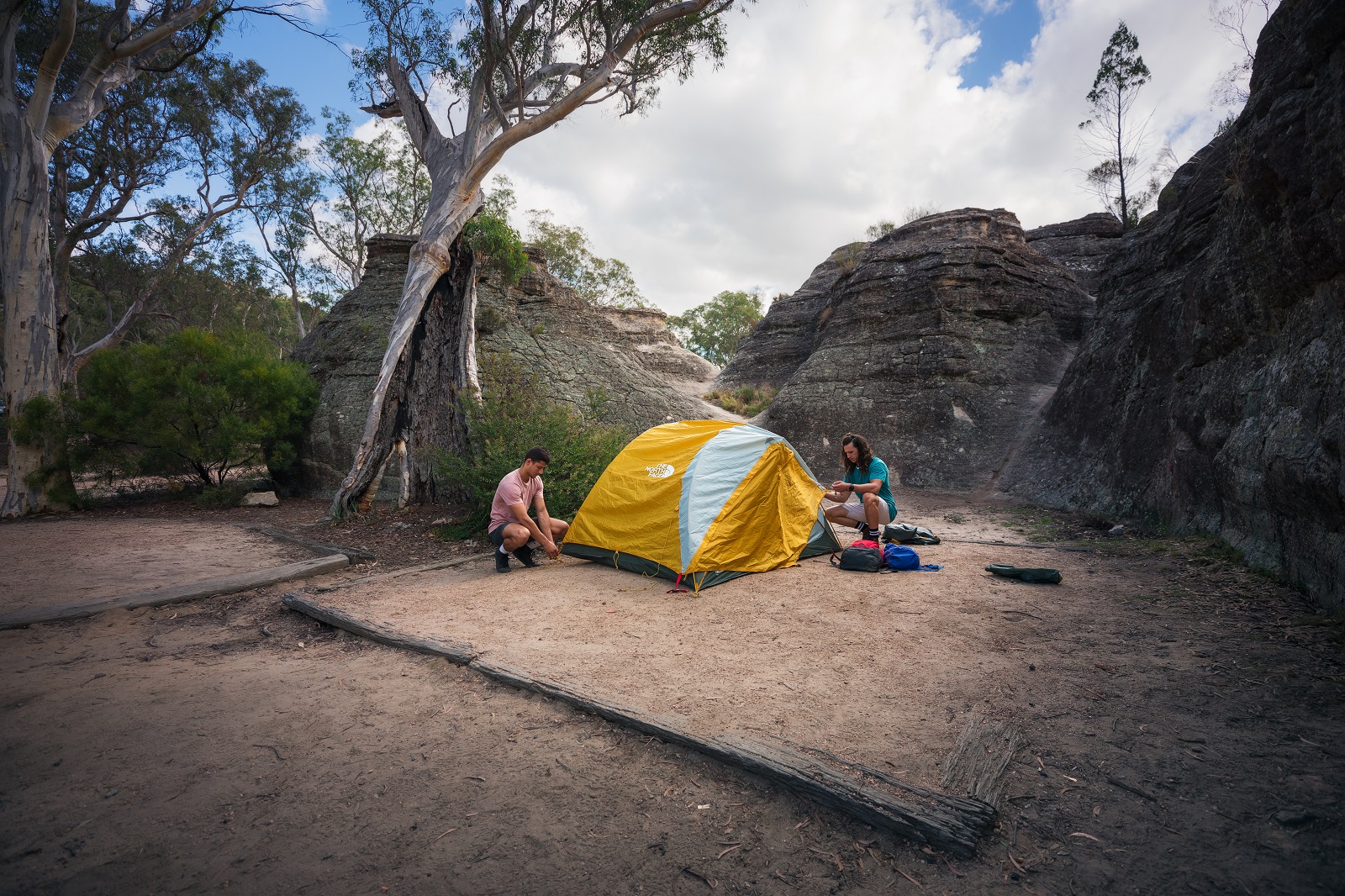 Two guys setting up a tent in Ganguddy-Dunns Swamp campground. Photo: Daniel Tran/DPIE