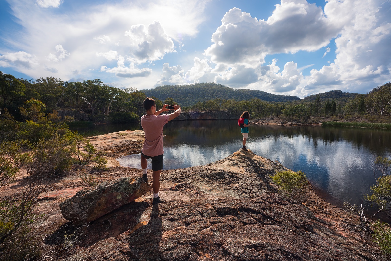 A guy taking a photo of a friend with the Cudgegong river in the background. Photo: Daniel Tran/DPIE