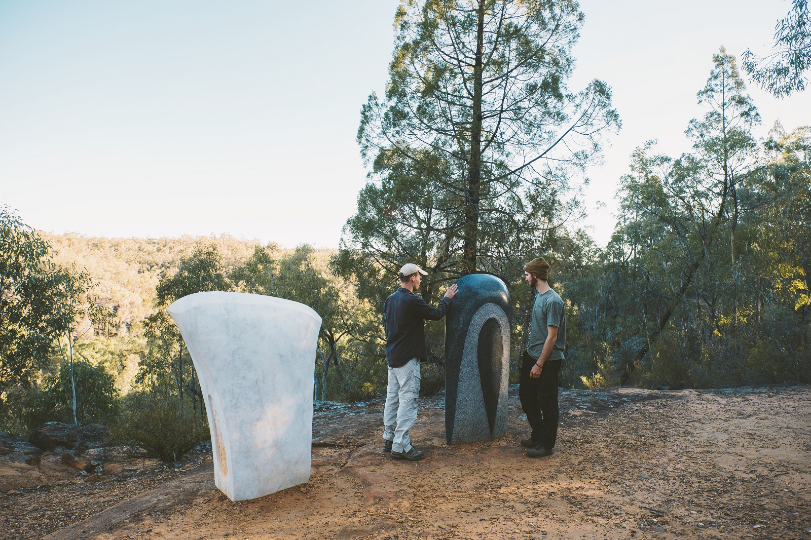 Two men admiring the sculptures on the Sculptures in the Scrub walking track in Timmallallie National Park. Photo credit: Harrison Candlin/DPIE
