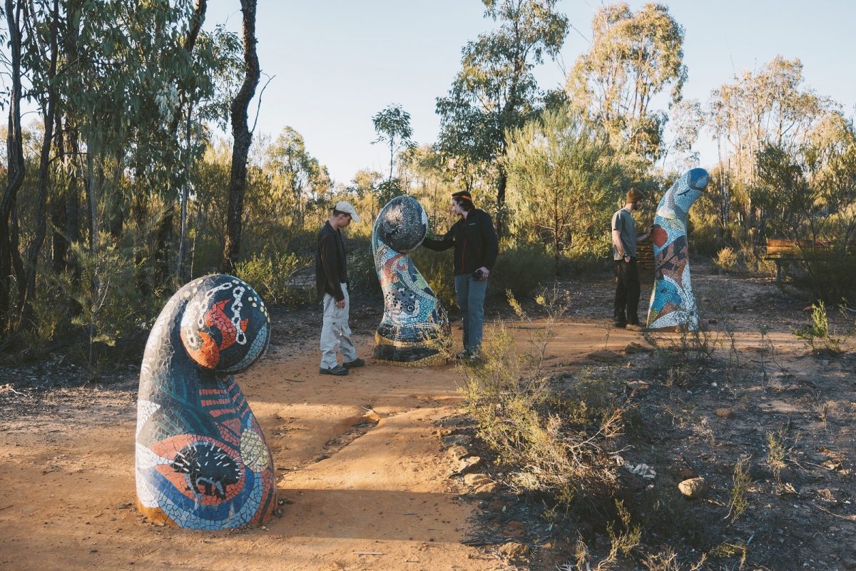 People admiring sculptures along the Sculptures in the Scrub walking track. Photo credit: Harrison Candlin/DPIE