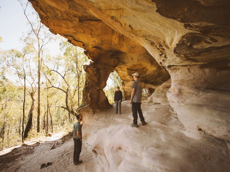 Three men in the Sandstone Caves at Pilliga Nature Reserve. Photo Credit: Harrison Candlin / DPIE