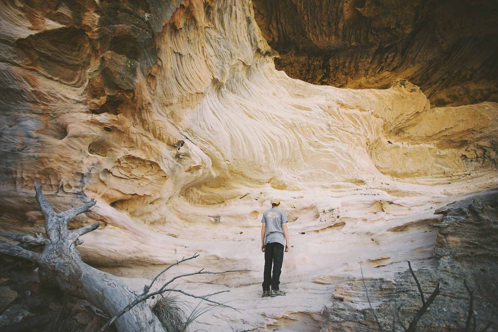 A man looking at the Sandstone Caves in Pilliga Nature Reserve. Photo: Harrison Candlin/DPIE