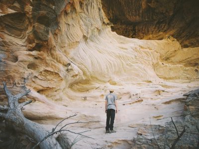 A man looking at the Sandstone Caves in Pilliga Nature Reserve. Photo: Harrison Candlin/DPIE