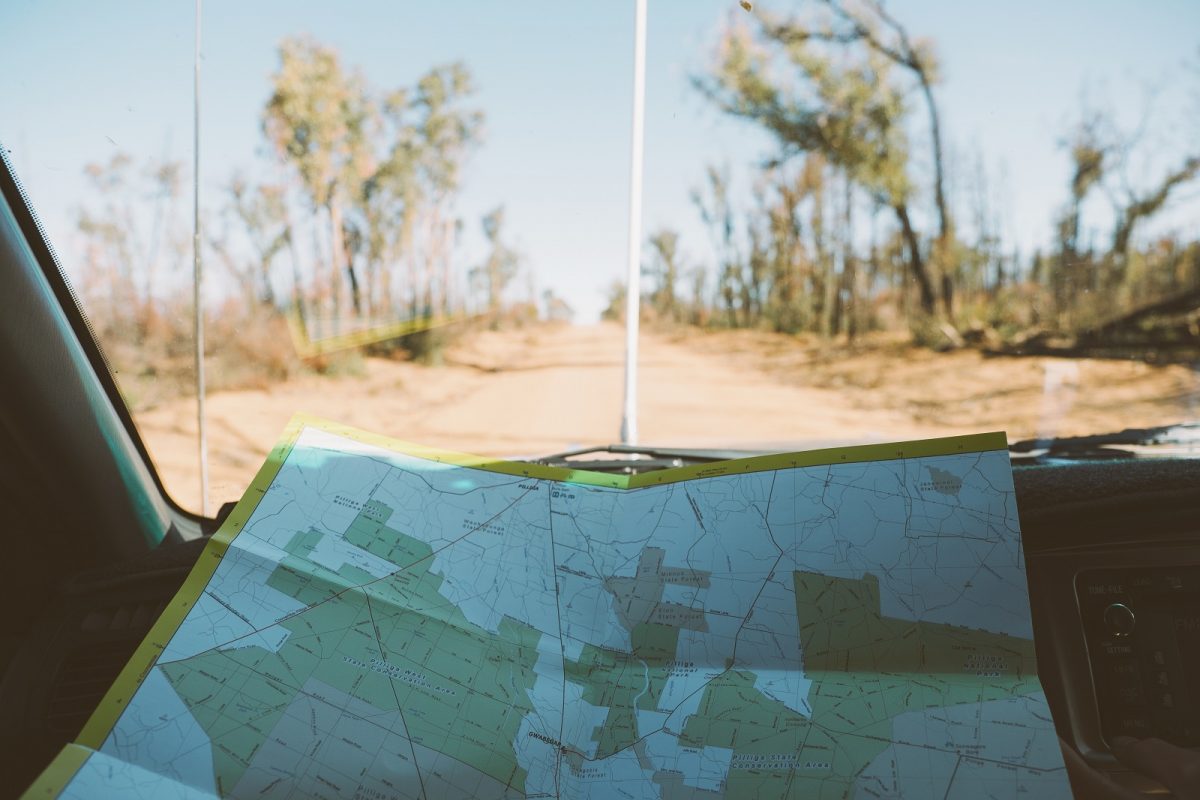 Viewing a map on a road trip to the Pilliga. Photo credit: Harrison Candlin/DPIE