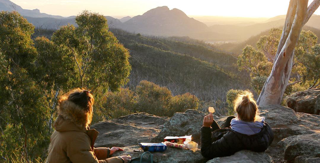 Two people having a sunset snack in a NSW national park. Photo: Chloe Kafte