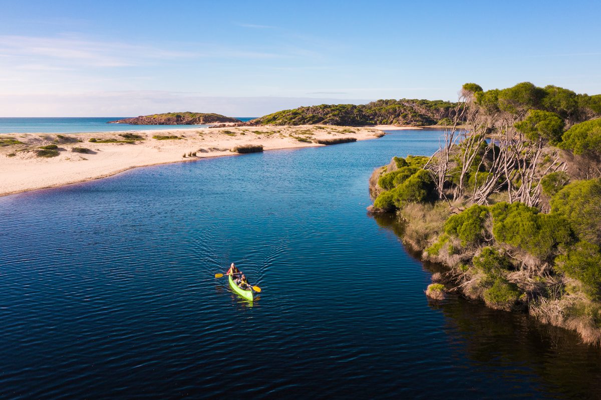 Two people canoeing in Bournda National Park. Photo: Daniel Parsons/DPIE