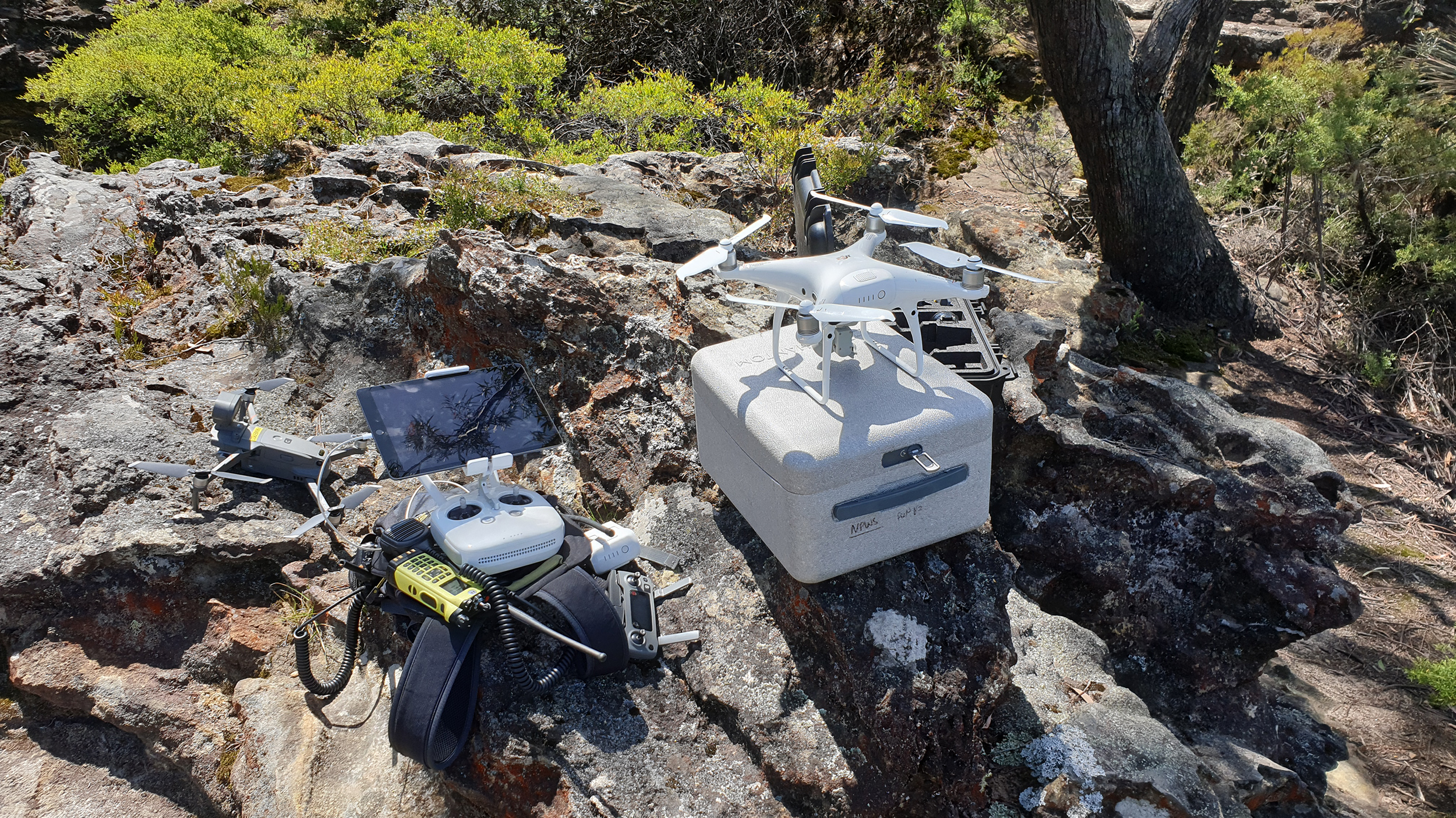 A drone set up, next to drone controls. Photo credit: Scott Colefax / DPIE