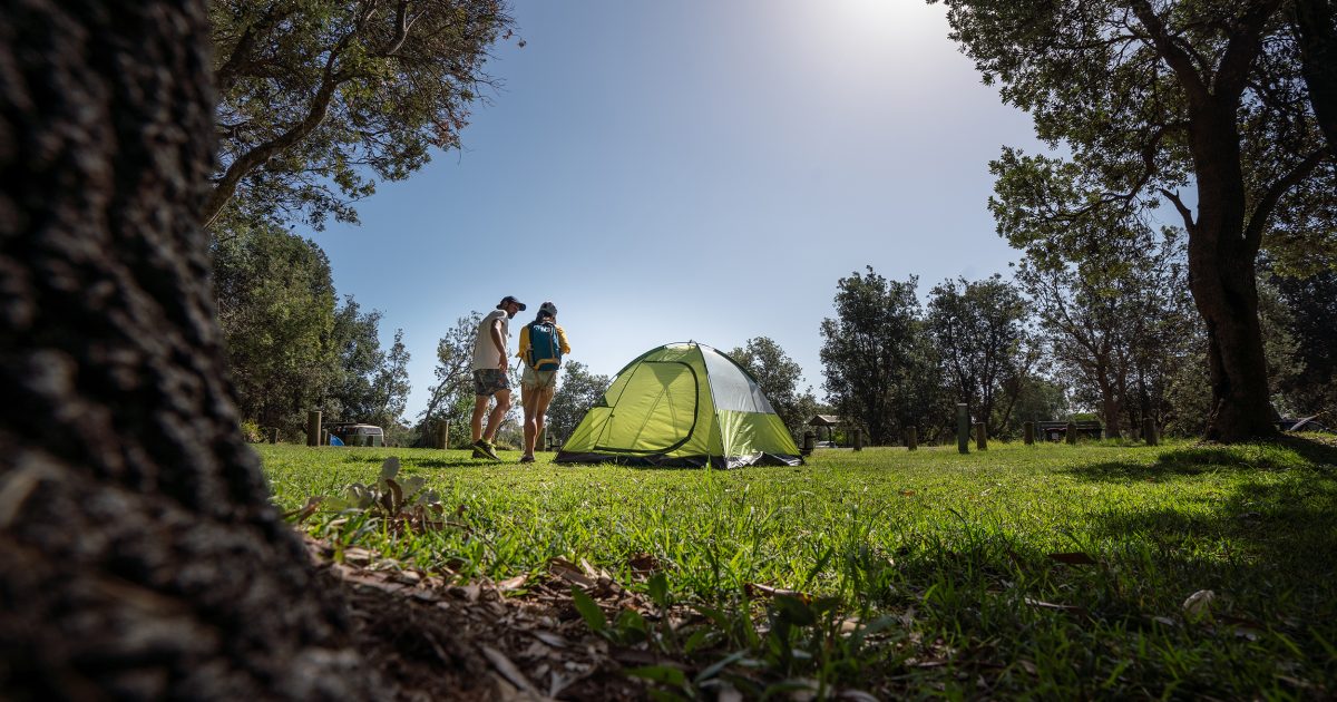 Two people near a tent in a NSW national park. Photo: Rob Mulally / DPIE