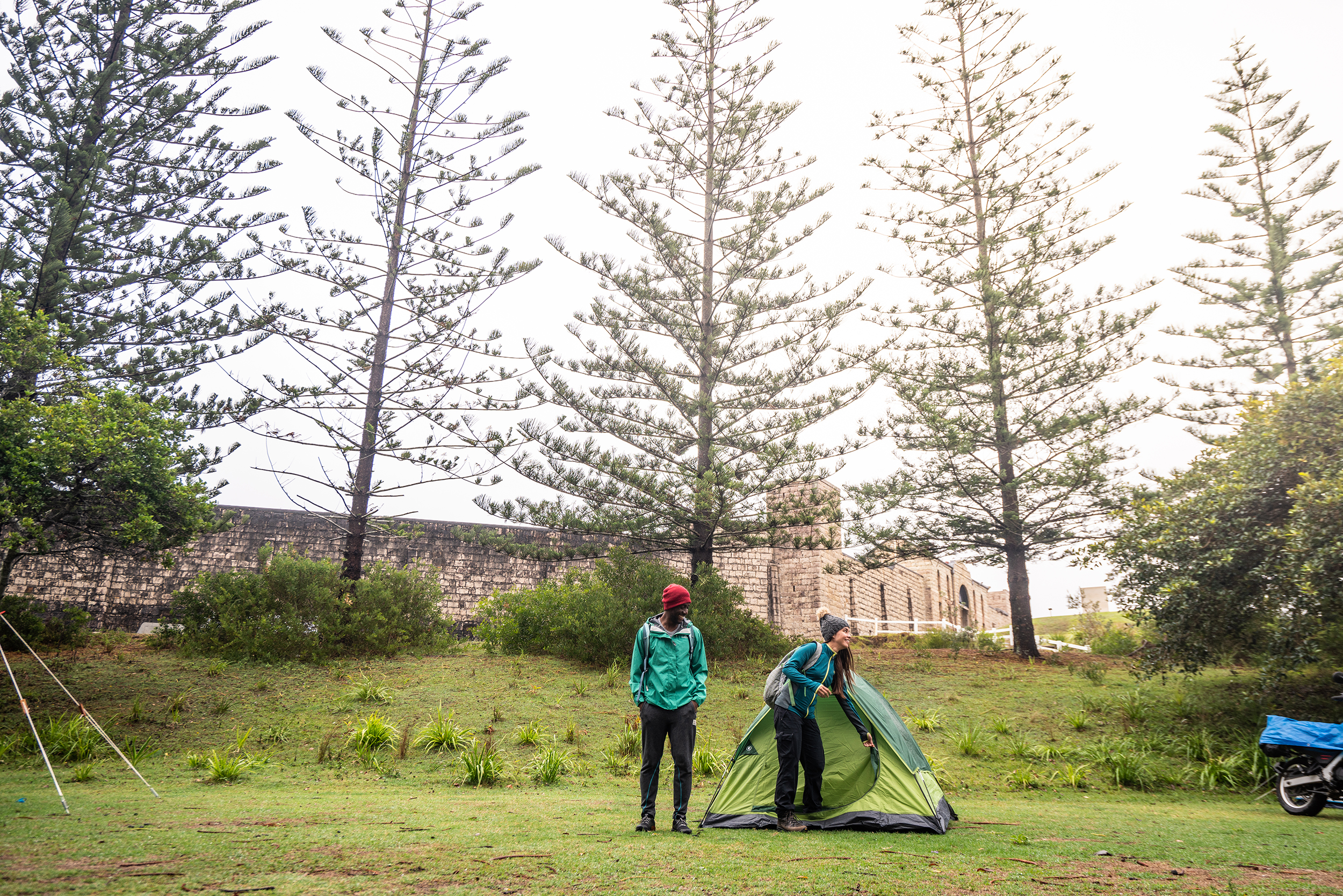 Two people next to a tent in Trial Bay Goal campground, Arakoon National Park. Photo: Rob Mulally / DPIE