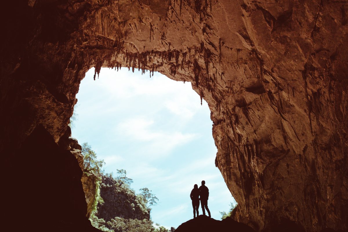 Silhouette of two people in a cave of Jenolan Karst Conservation Area. Photo: Tima Clark