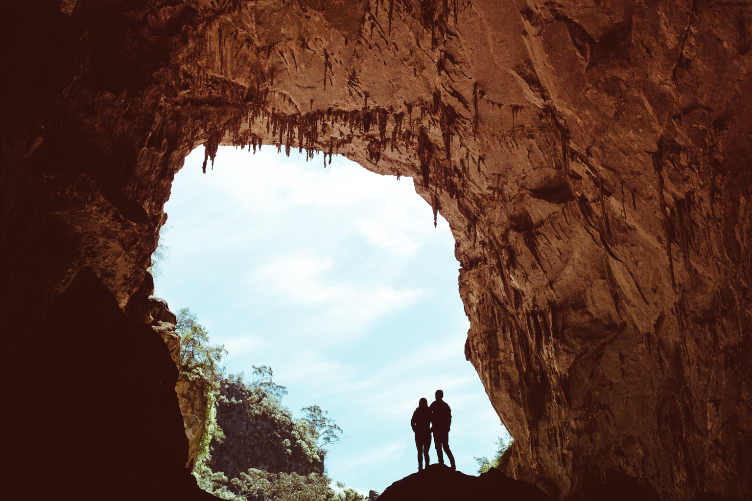 Silhouette of two people in a cave of Jenolan Karst Conservation Area. Photo: Tim Clark