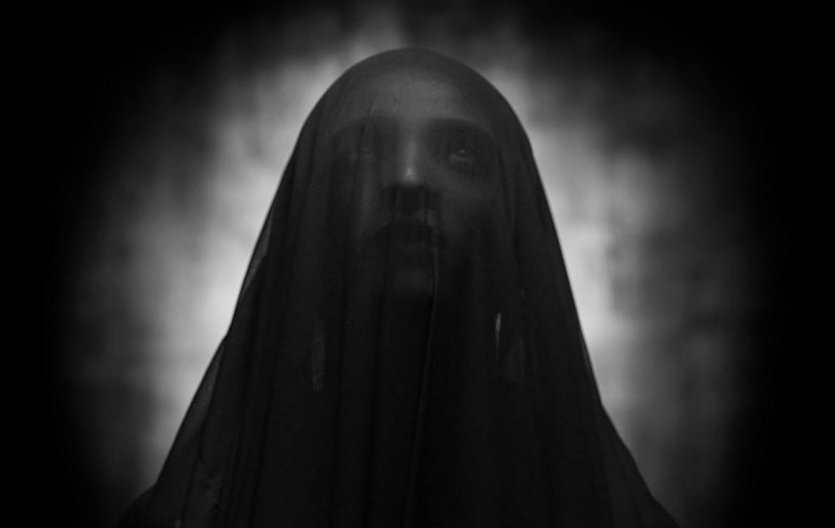 Shadowed image of a person with head covering. Photos: Faizi Ali via Pexels
