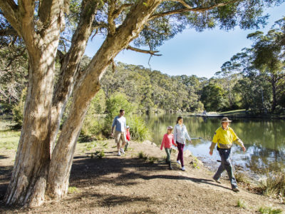 A family walking and following a ranger in Royal National Park. Photo credit: Simone Cottrell / DPE