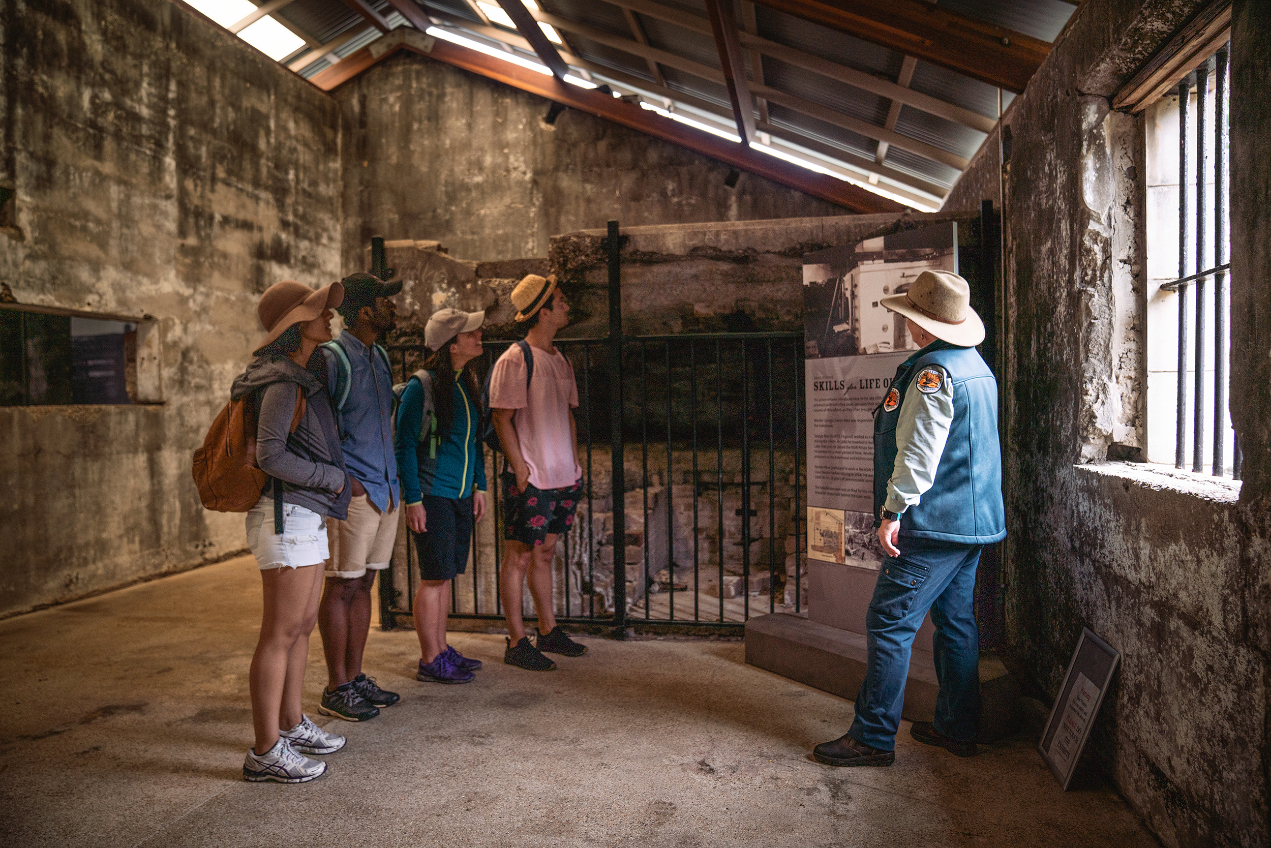 Four people on a guided Trial Bay Gaol tour, Arakoon National Park. Photo credit: Rob Mulally / DPE