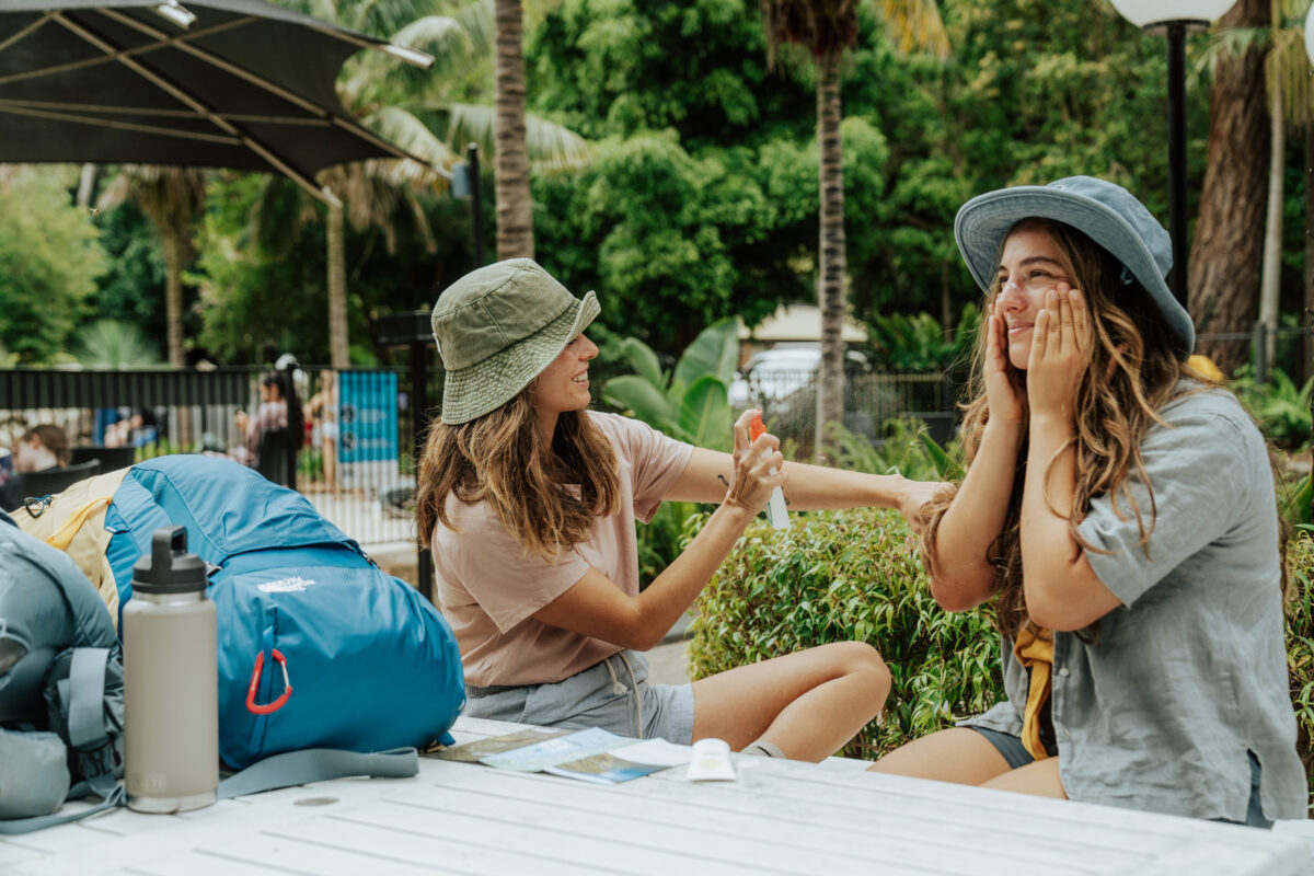 Friends applying sunscreen at Murramarang Beachfront Resort. Photo credit: Remy Brand © Remy Brand / DPE