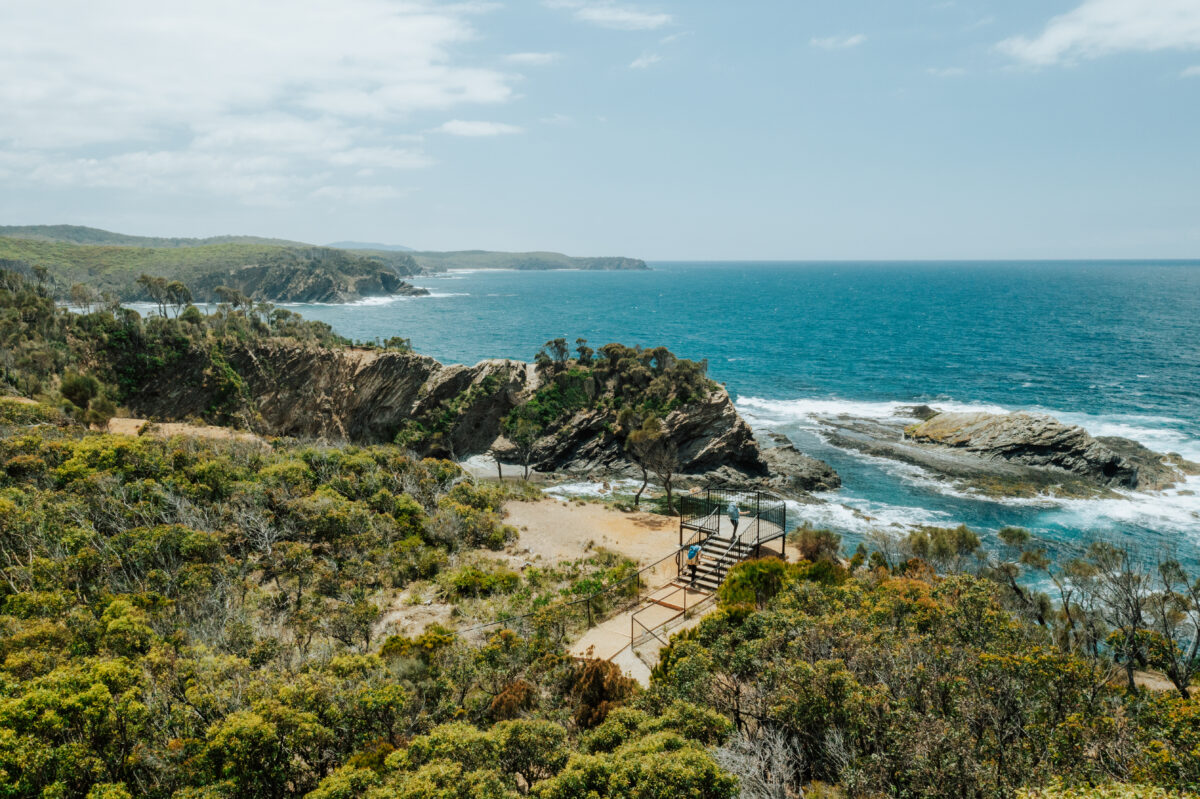 Aerial of two people at the North Head Lookout, Murramarang South Coast walk. Photo credit: Remy Brand / DPE