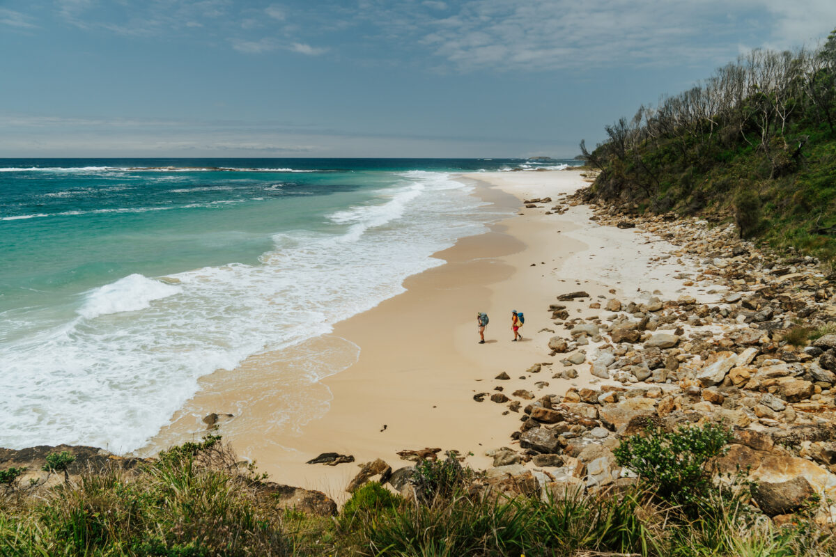 Two people on the beach, on the Murramarang South Coast Walk, Murramarang National Park. Photo credit: Remy Brand © Remy Brand / DPE